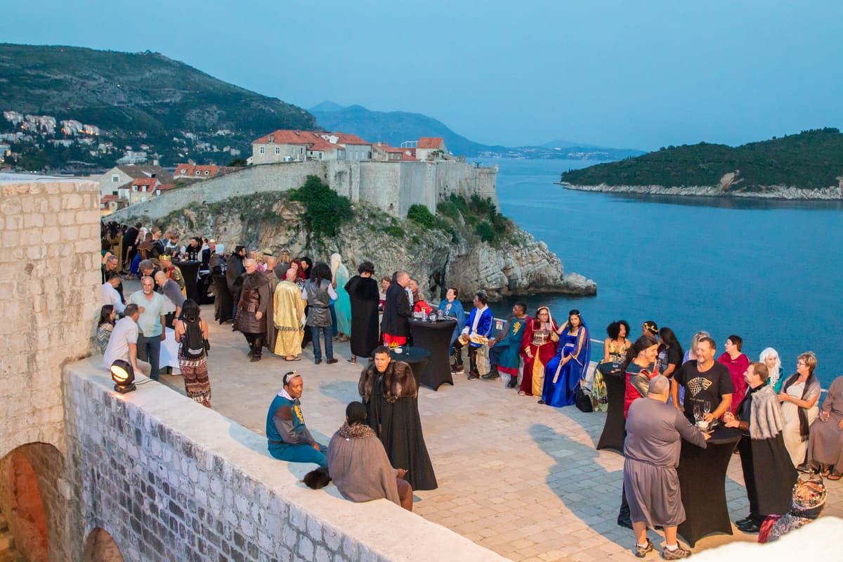 Guests at a gala dinner on the Dubrovnik city walls above the sea
